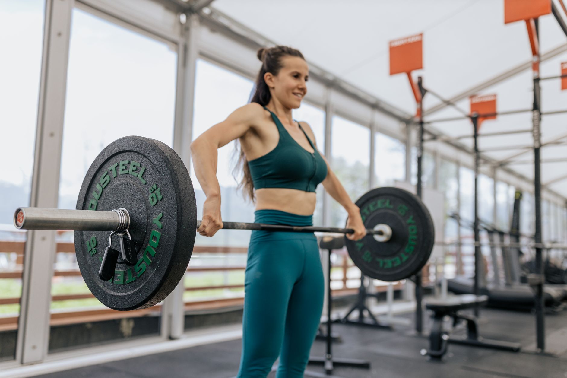 A lifter driving through the second pull of a lift, barbell rising